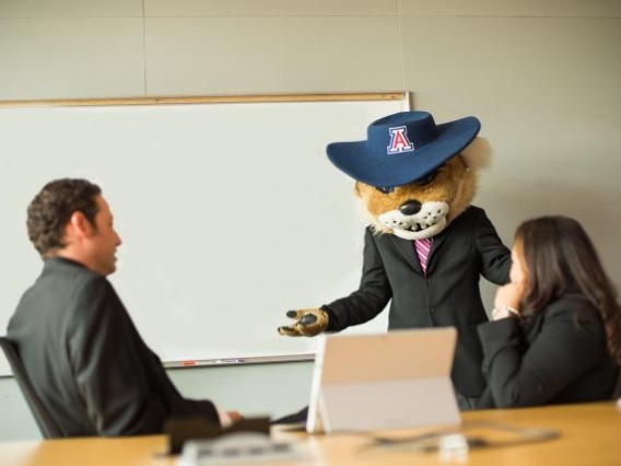 Wilbur leading a discussion in front of a white board
