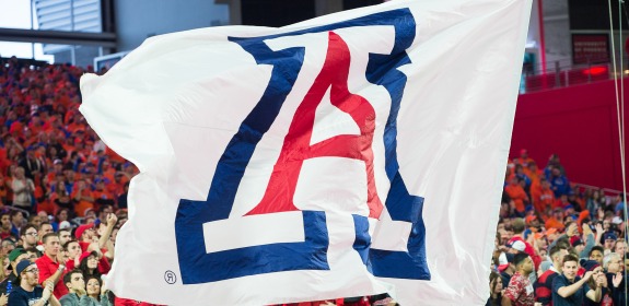 Large "A" flag in front of crowd at a football game