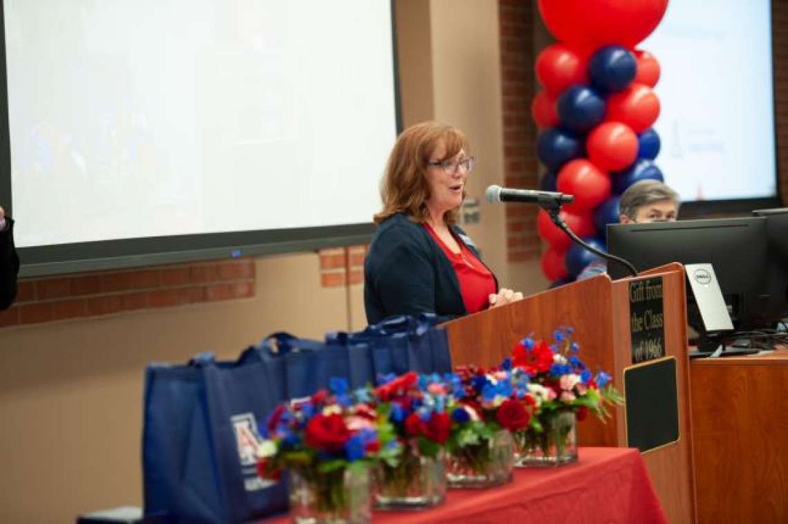 Woman speaking at podium at College of Nursing Homecoming Breakfast