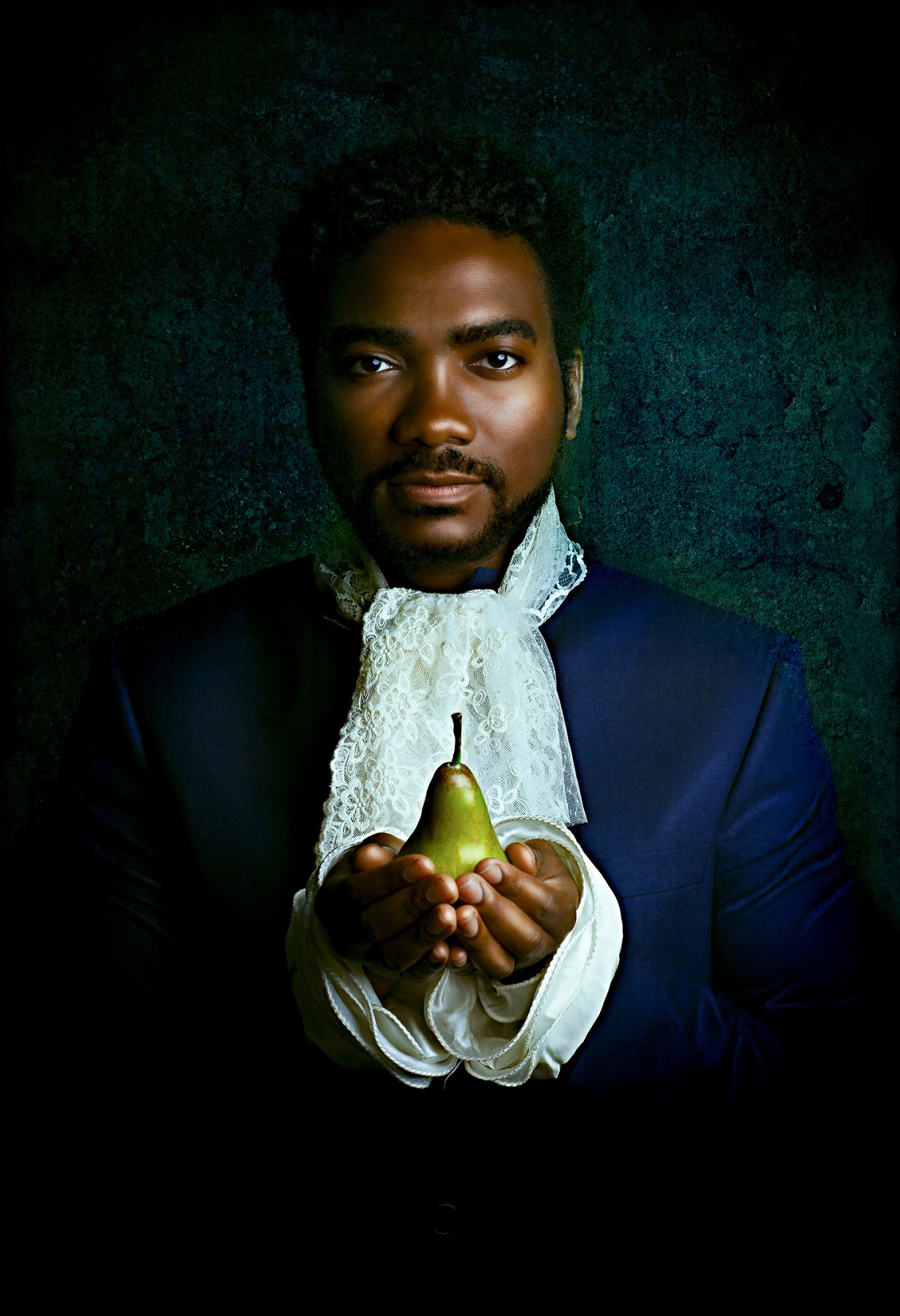 Black man holding pear