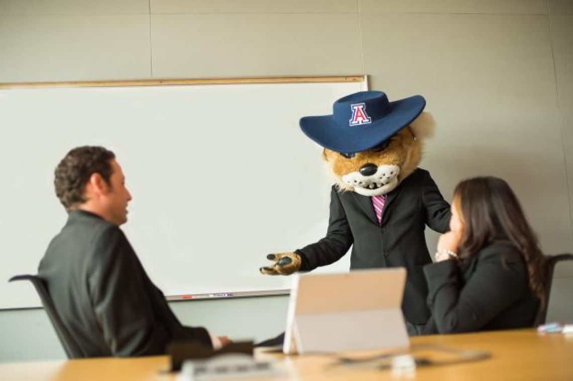 Wilbur leading a discussion in front of a white board