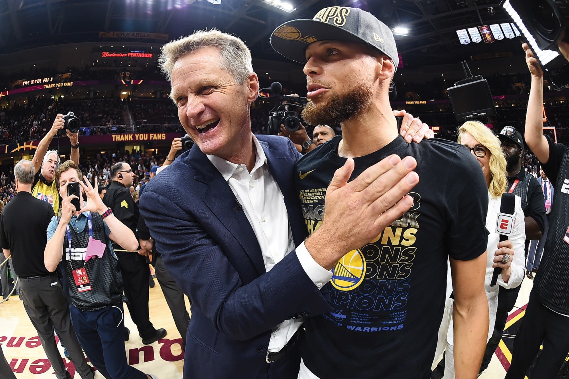 A photograph of Steve Kerr and Stephen Curry celebrating a big win