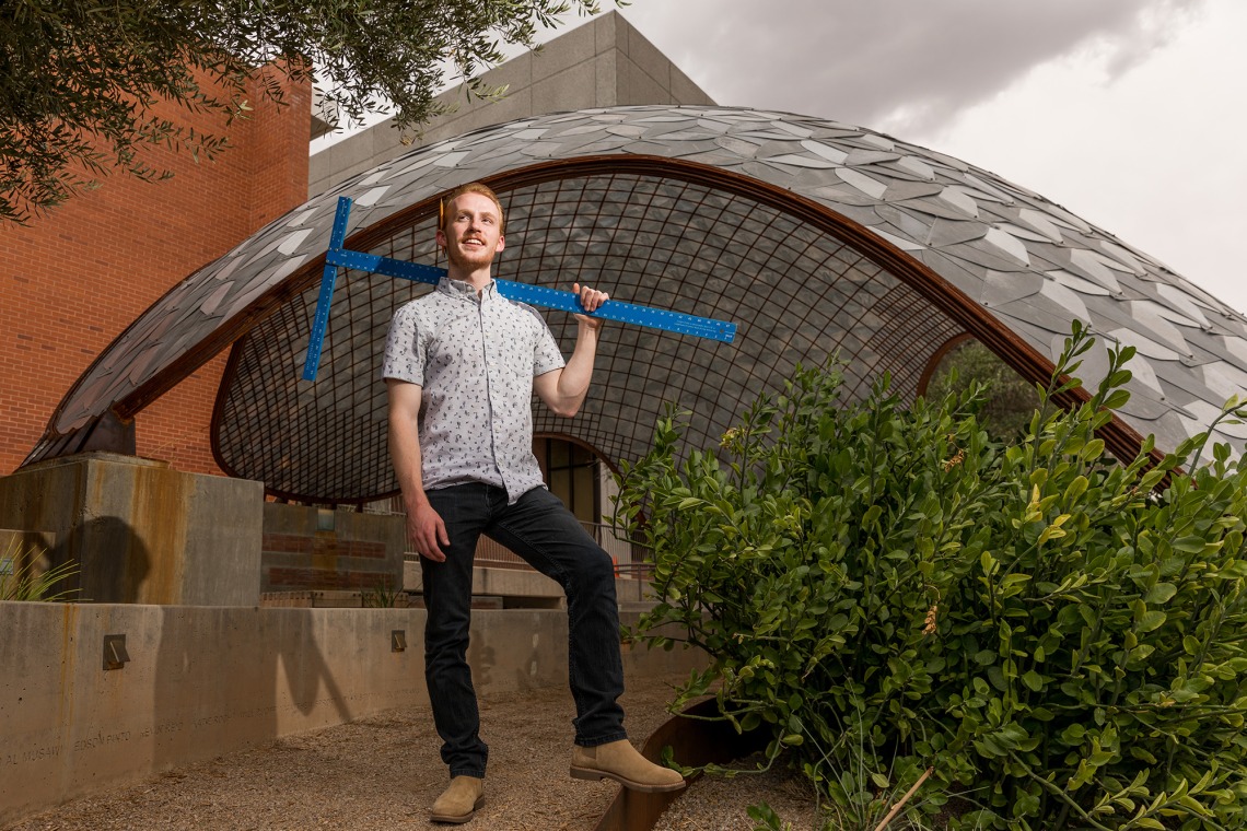 A photograph of Ben Stewart, standing proudly outside the Sonoran Pentapus shade structure