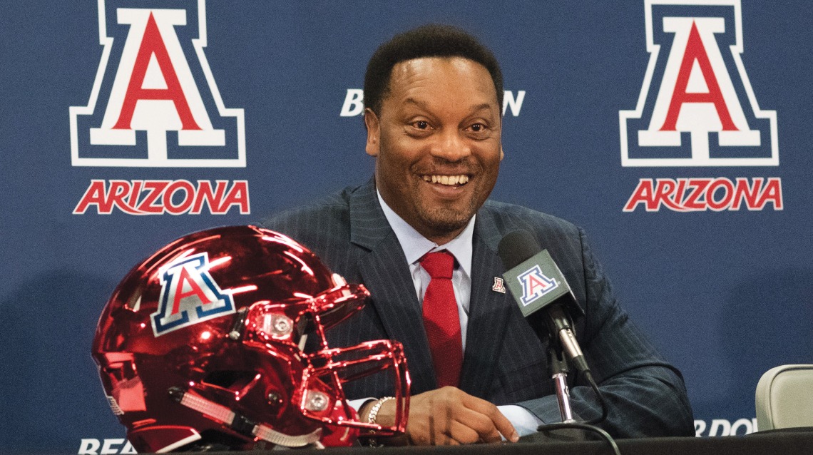A photograph of Kevin Sumlin at a press conference 
