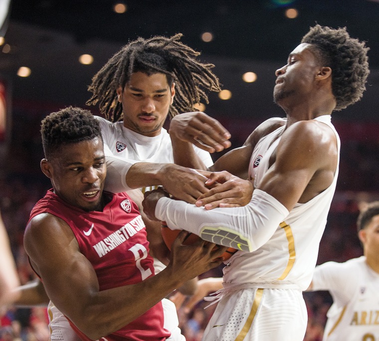 A photograph of the Arizona Wildcats defending a basketball against Washington State