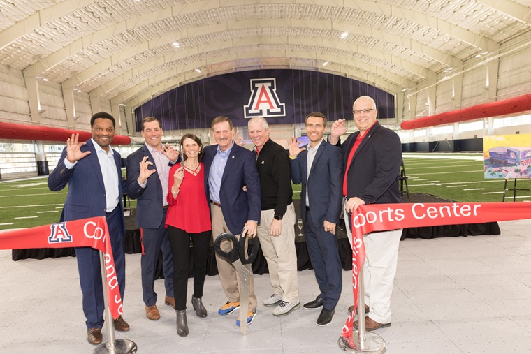 A photograph of the ribbon-cutting event with the Davis family, Kevin Sumlin, Dave Heeke and President Robert C. Robbins 