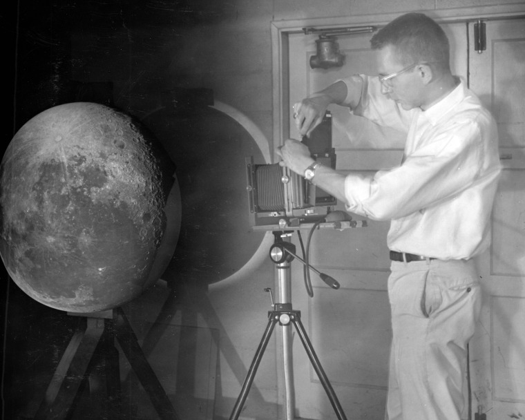 A photograph of William Hartmann projecting photographic plates of the moon onto a white hemisphere. 