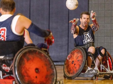 Josh Wheeler passes ball during wheelchair rugby game