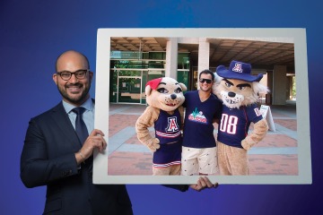 A photograph of Devin Sreecharana with Wilbur and Wilma Wildcat