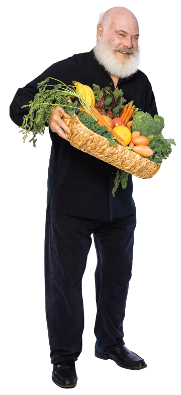 A photograph of Andrew Weil smiling and holding a basket full of fruits and vegetables